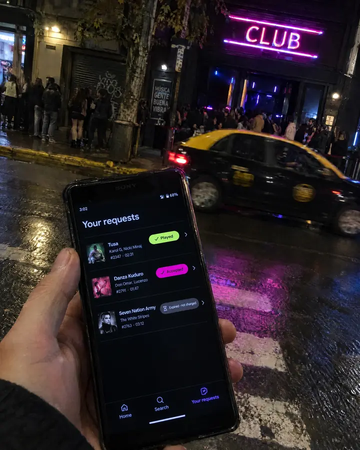 Outside the club in the early hours, someone checks their requests: one played, one accepted and one expired with no charge.